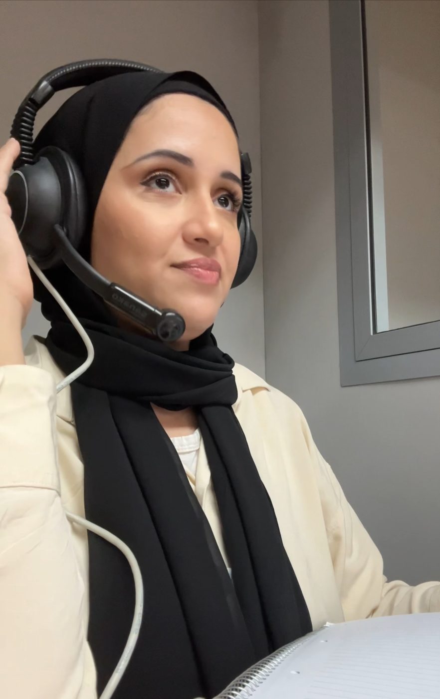 Marwa wearing an interpreter's headset