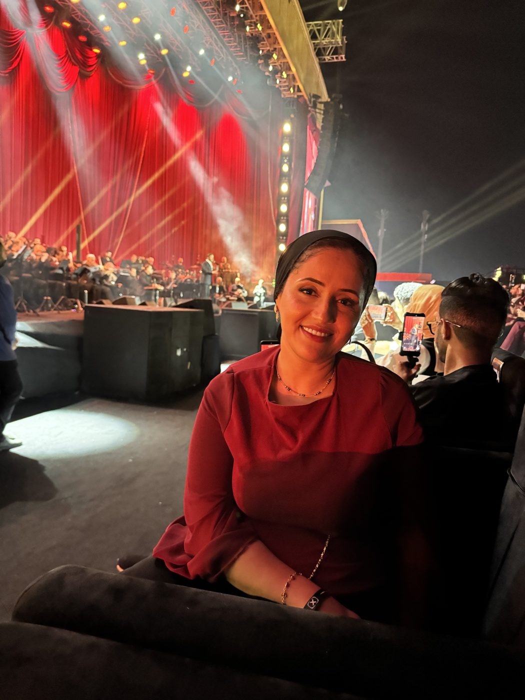 Marwa smiling at a live orchestra concert